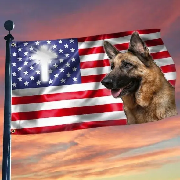 A german shepherd dog sitting on top of an american flag.